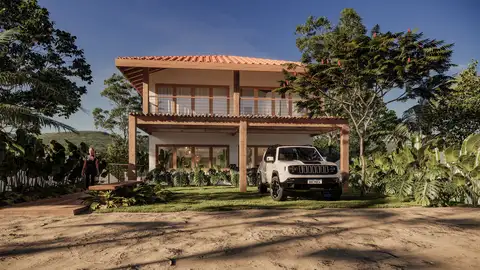 A beautiful two-story house in the Bahian style, nestled on a steeply sloping plot. The four suites are located on the upper floor, allowing for complete integration of the ground floor spaces and a breathtaking view of a beautiful forest